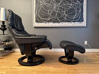 Side view of recliner and ottoman showing profile and swivel base