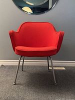 Front view of chair showcasing fullback design and red upholstery.
