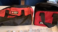 Overview of both Porter-Cable and Bauer tool bags on countertop