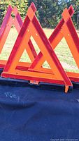 Three unfolded reflective triangles displayed upright