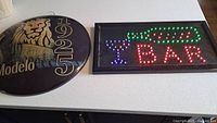 Modelo round sign and LED bar sign side by side