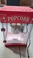 Front view of West Bend popcorn machine showing brand name and overall structure