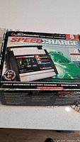Retail box front showing Schumacher SpeedCharge branding and 6-amp rating