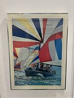 Framed offset lithograph poster showing a yacht with colorful sails on water from the 1986 America's Cup.