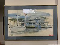 Framed watercolor painting showing sailboats and a marina building good lighting and clear image