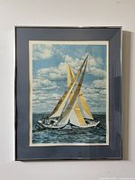 Full framed lithograph showing two sailboats with yellow sails on water under a cloudy blue sky.