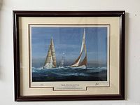 Front view of the framed print showing two yachts racing with a lighthouse in the background. Good condition with visible signature and title.