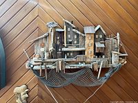 Full view of large 3D boating themed wall art mounted on wood chevron panel wall