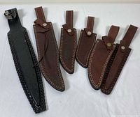 Front view of all six leather sheaths laid out