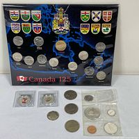 Front view showing Canada 125 set at top and loose coins with 1967 set below