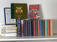 Full lot on shelf showing 22 books including front covers and spines