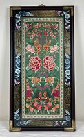 Full view of embroidered panel in frame