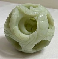 Overall view of carved jade puzzle ball showing outer relief and interior spheres