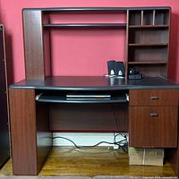 Front view of desk showing hutch, desktop, drawers, keyboard tray