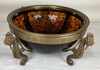 Overall view of glass bowl seated in brass stand
