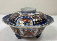 Covered Imari bowl with lid in place, showing exterior decoration and feet