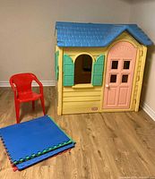 Playhouse front view with chair and stacked mats