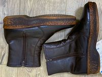 Side view of both boots showing leather uppers, zippers and mottled midsoles