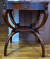 Front view showing entire table, ring pull mount, leg design, lower shelf