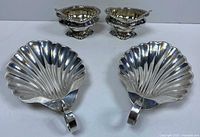 Front view of two shell dishes and two salt cellars