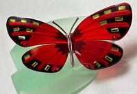 Front view of red crystal butterfly on green frosted base