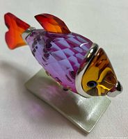 Left-side view of multicolour crystal fish on stand