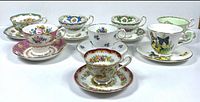 All eight teacup and saucer sets grouped