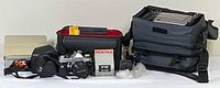 Overall lot showing Pentax SLR, bags, projector case, screen panel