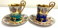 Two demitasse cups on saucers showing overall design and colors