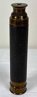 Telescope standing closed showing leather wrap and eyepiece