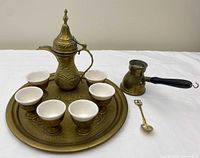 Full set showing brass dallah, six cups, tray, Turkish pot, spoon