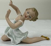 Front angled view showing ballerina pose, dress, face paint