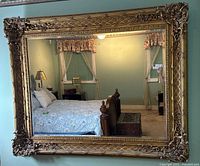 Full view of mirror showing ornate gold frame and reflection