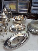Group shot of bread plate and three serving bowls on table