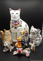 Group shot of all eight cat figurines