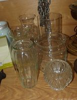 Group of clear glass vases on shelf