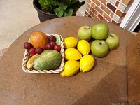 top view of basket with assorted fruit, lemons, apples