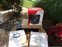 Group shot of all four boxed items: Frigidaire mini cooler, Kyolly monitor stand, Kenmore kit, LDR faucet