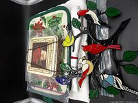 Overview of lot showing wall hanging, coaster tin, linens in bags