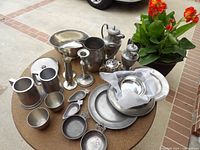 all pewter items on round table showing quantity and variety