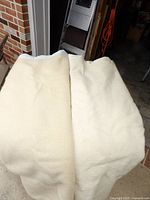 Two off-white wool blankets draped side by side
