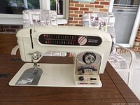 Front view of sewing machine showing pattern selector panel and controls