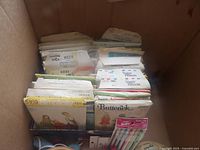 Box of vintage sewing patterns showing Simplicity, Butterick, Vogue envelopes