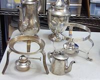 Group shot of two coffee pots, creamer, and two burner stands