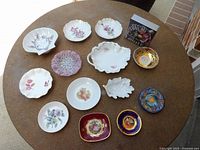 Overhead view of all 14 trinket plates and bowls