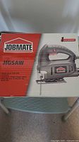 Photo showing the Jobmate jigsaw in its original box with product features and branding visible.