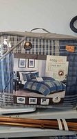 Packaged CozySoft twin size plaid bedding set showing exterior packaging with brand, pattern, and size information