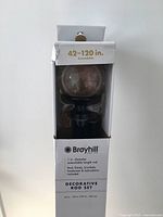 Close-up photo of boxed Broyhill decorative rod set showing details on packaging including diameter, extendable length 42-120 inches and included hardware