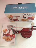 Image showing Cucina Pro apple peeler packaging, instruction manual, and the apple peeler device on countertop