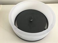 Top angle photo showing the round black base and surrounding white diffuser of the flush mount ceiling lamp.